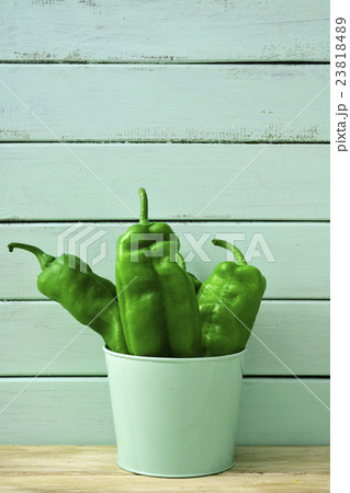 raw green peppers in a pale green bucket raw green peppers in a pale green bucket 23818489