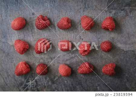 Raspberries on the dark stone background 23819394