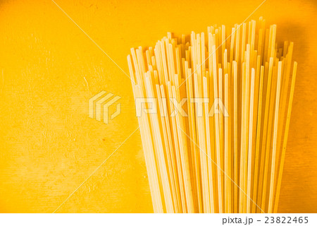 Raw spaghetti on the yellow background horizontal Raw spaghetti on the yellow background horizontal 23822465
