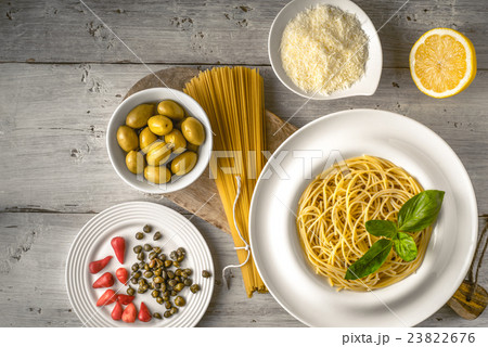 Raw and cooked spaghetti with different appetizer Raw and cooked spaghetti with different appetizer 23822676