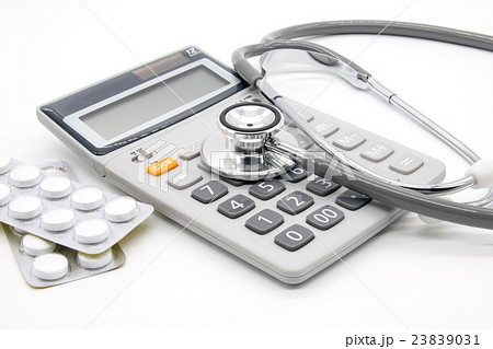 Calculator and stethoscopes on white background Calculator and stethoscopes on white background 23839031