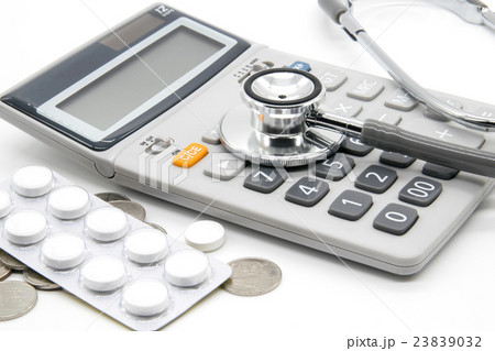 Calculator and stethoscopes on white background Calculator and stethoscopes on white background 23839032