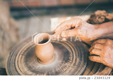 Potter sculpts a clay pot Potter sculpts a clay pot 23843129