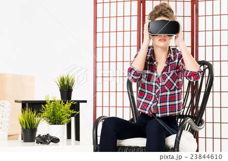 Girl getting experience using VR glasses of 23844610