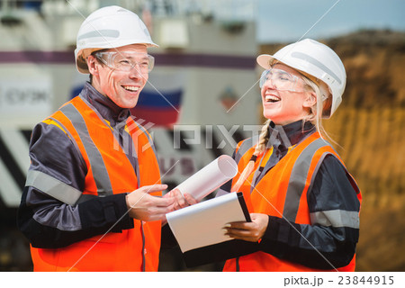 Two people working Two people working 23844915