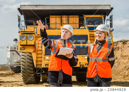 Two people working Two people working 23844929