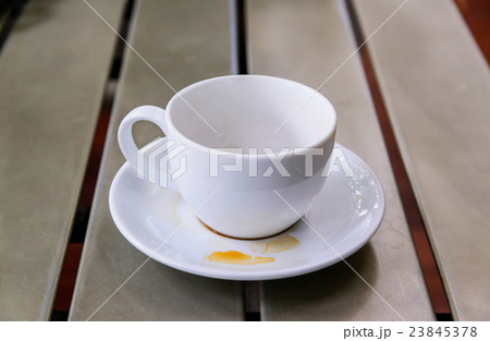 An empty cup on a wooden table An empty cup on a wooden table 23845378
