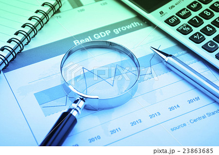Magnifying glass and calculator on growth graph 23863685