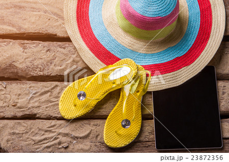 Flips flops near a tablet. Flips flops near a tablet. 23872356