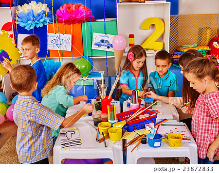 Children with teacher woman painting on paper in 23872833