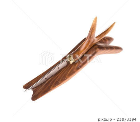 Bowie knife with bone grip on wooden rest. 23873394