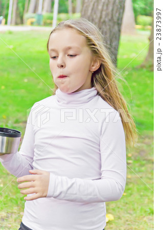 Cute girl drinking beverage 23873997