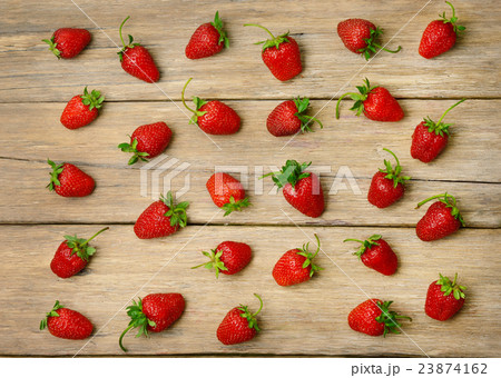 strawberries on a wooden surface background 23874162