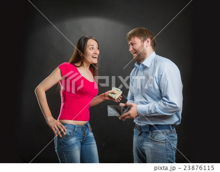 Woman taking husband's money 23876115