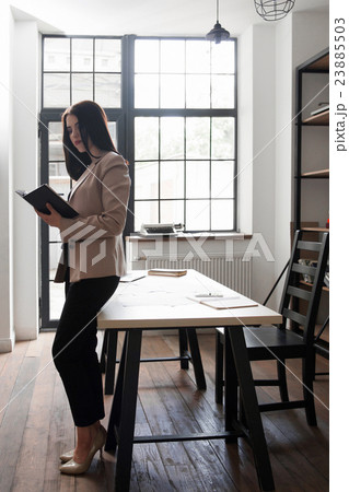 Beautiful business woman writing in her notebook Beautiful business woman writing in her notebook 23885503
