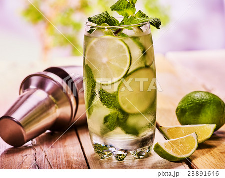 On wooden boards is glasses with mohito. 23891646