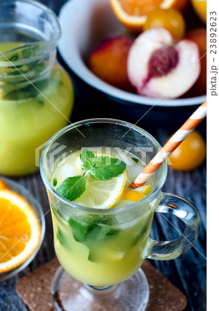 Refreshing lemonade drink and ripe fruits 23892623
