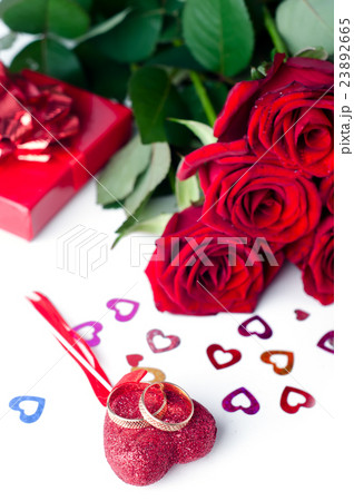 Gold wedding rings and rose isolated 23892665