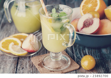 Refreshing lemonade drink and ripe fruits.  23892700