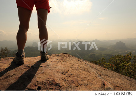 young woman hiker legs on  mountain peak rock 23892796