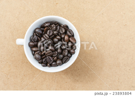 Coffee cup and coffee bean on a wooden table 23893804
