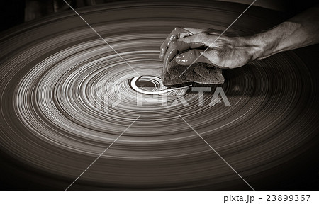 Man's hand on a potter's wheel 23899367