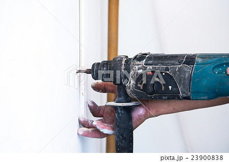 close up of electric drill making hole in a wall close up of electric drill making hole in a wall 23900838