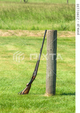 Rifle on a green meadow 23901130