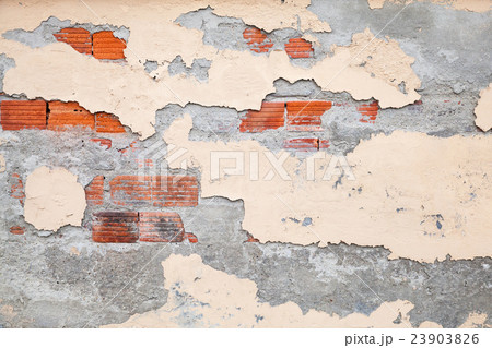 Old brick wall with damaged stucco and paint 23903826