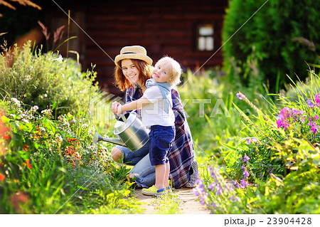 Toddler boy with mother in garden 23904428