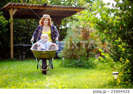 Toddler boy with mother in garden Toddler boy with mother in garden 23904429