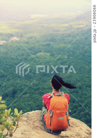 woman hiker enjoy the view at mountain peak cliff woman hiker enjoy the view at mountain peak cliff 23906066