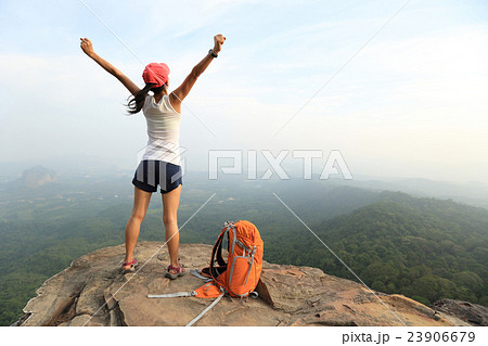 cheering youngwoman hiker open arms mountain peak 23906679