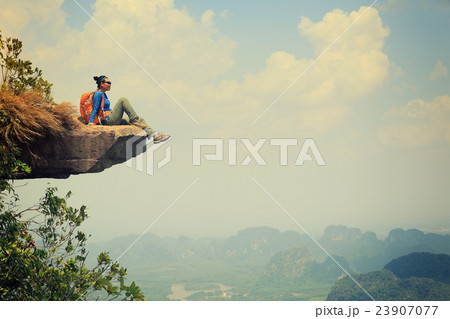 woman hiker enjoy the view at mountain peak cliff 23907077