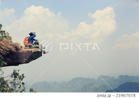 woman hiker enjoy the view at mountain peak cliff 23907078