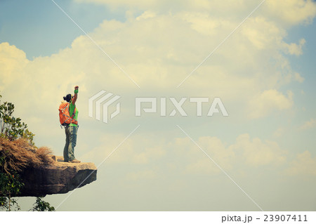 young woman hiker on mountain peak cliff 23907411