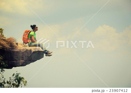 young woman hiker on mountain peak cliff 23907412