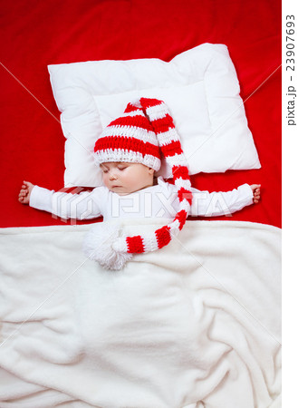 Sleepy baby on red blanket 23907693