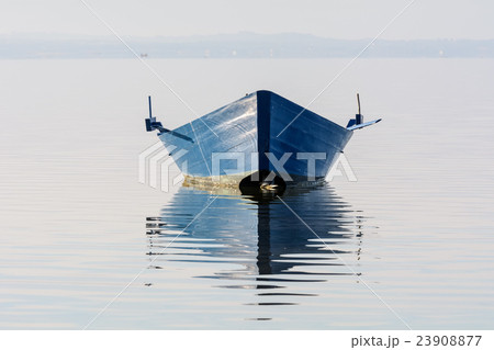 Bow of the boat is reflected in the water 23908877