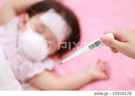 体調不良の赤ちゃんをママが看病するの写真素材