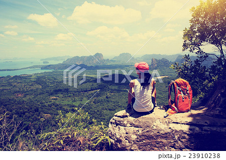 young woman hiker hiking at seaside mountain cliff 23910238