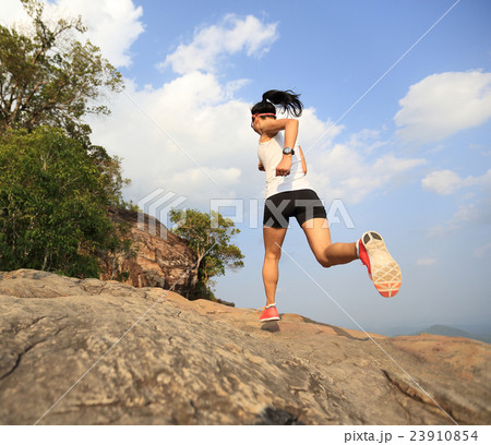 young asian woman runner running on mountain peak 23910854