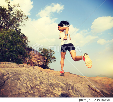 young asian woman runner running on mountain peak young asian woman runner running on mountain peak 23910856
