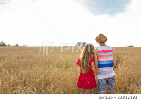 back view of a couple holding each other and 23912193