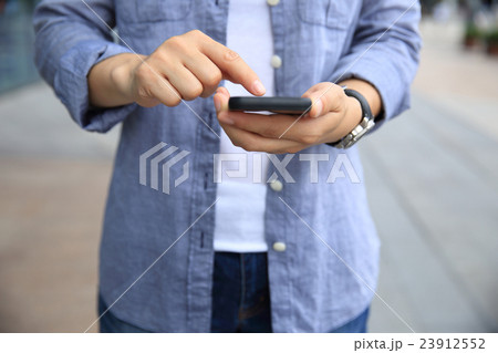 woman hand with smart phone in modern city 23912552