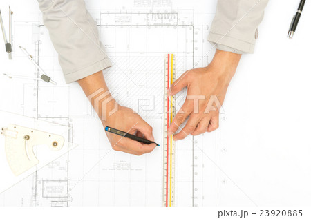 Architect working on blueprint 23920885