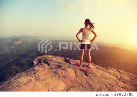 young woman enjoy the view on mountain peak young woman enjoy the view on mountain peak 23922780