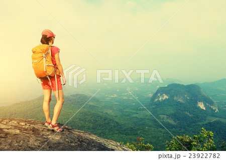 young woman hiker at mountain peak cliff young woman hiker at mountain peak cliff 23922782