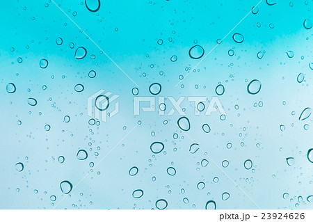 Water drops background. Water drops on glass window over blue sky. 23924626