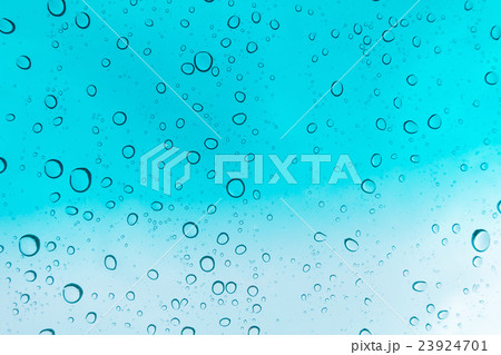 Water drops background. Water drops on glass window over blue sky. 23924701